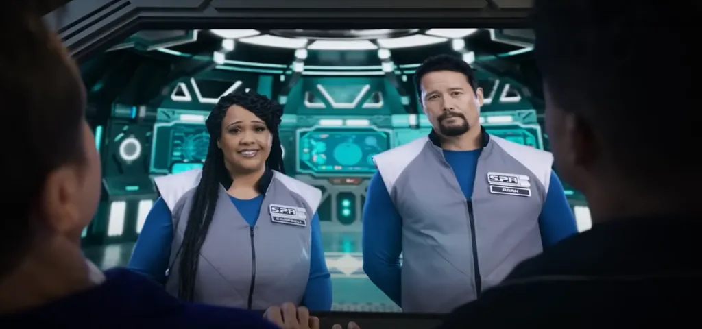 Adam e Aisha vão mandar apoio moral do espaço (Imagem: Reprodução/Netflix)