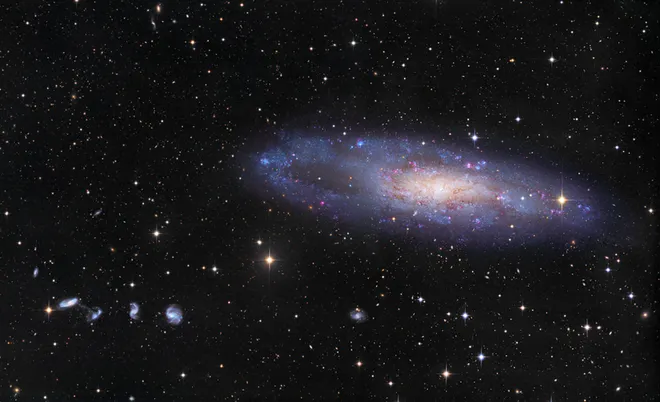 A NGC 247 tem cerca de 70 mil anos-luz de diâmetro e o "vazio de estrelas" é visível em sua extremidade esquerda nesta imagem (Imagem: Reprodução/CHART32 Team/Johannes Schedler)