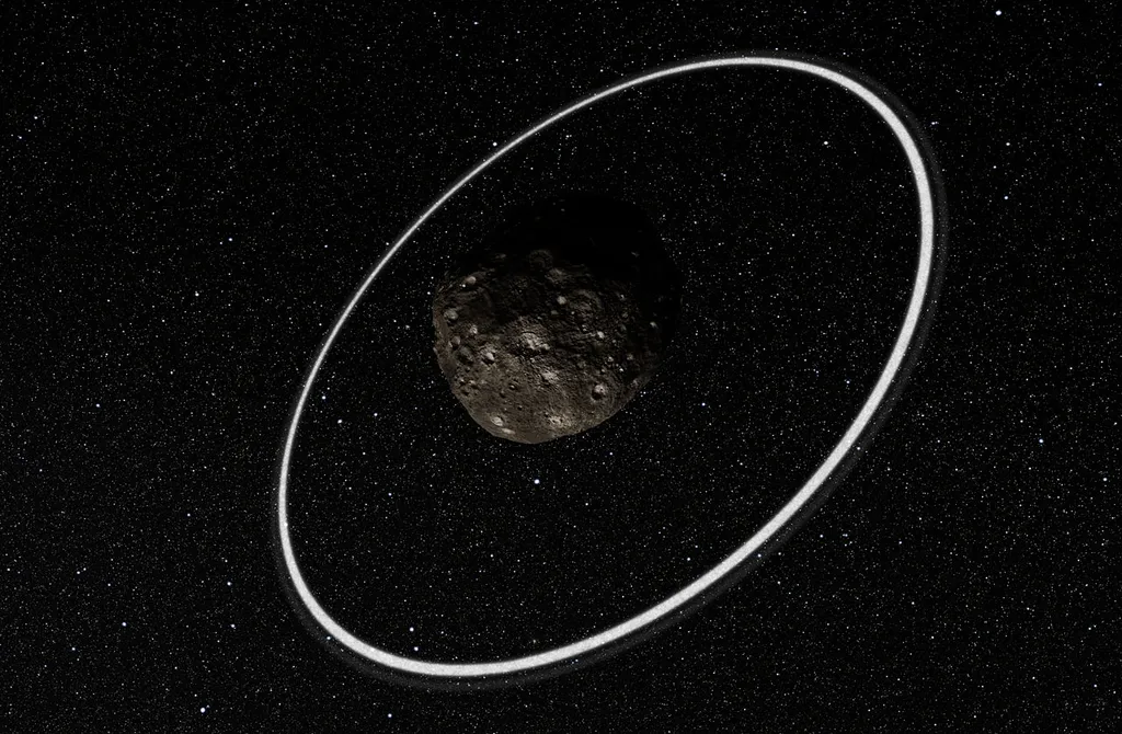 Representação de Cáriclo, um dos poucos objetos do Sistema Solar que é cercado por anéis (Imagem: Reprodução/ESO/L. Calçada/M. Kornmesser/Nick Risinger)