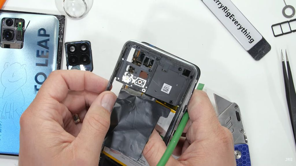 Diferente de outros celulares, o frame de plástico do Realme 8 Pro é removível, sendo parafusado junto às proteções dos componentes (Imagem: Reprodução/JerryRigEverything)
