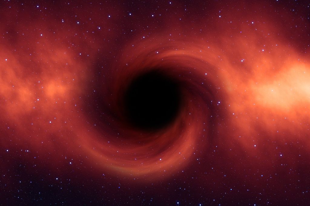 Esta é uma simulação de um buraco negro. Na teoria das fuzzballs, o horizonte de eventos (a borda do ponto escuro central) é a fronteira não apenas do limiar onde a velocidade de escape é igual à velocidade da luz, mas também delimita a superfície física da fuzzball em si (Imagem: Reprodução/Gerd Altmann/Pixabay)