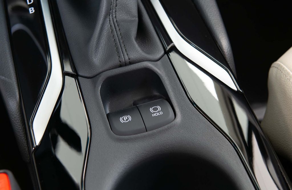 Corolla Cross 2025 trocou (finalmente) o freio de estacionamento no pé por um botão no console (Imagem: Divulgação/Toyota)