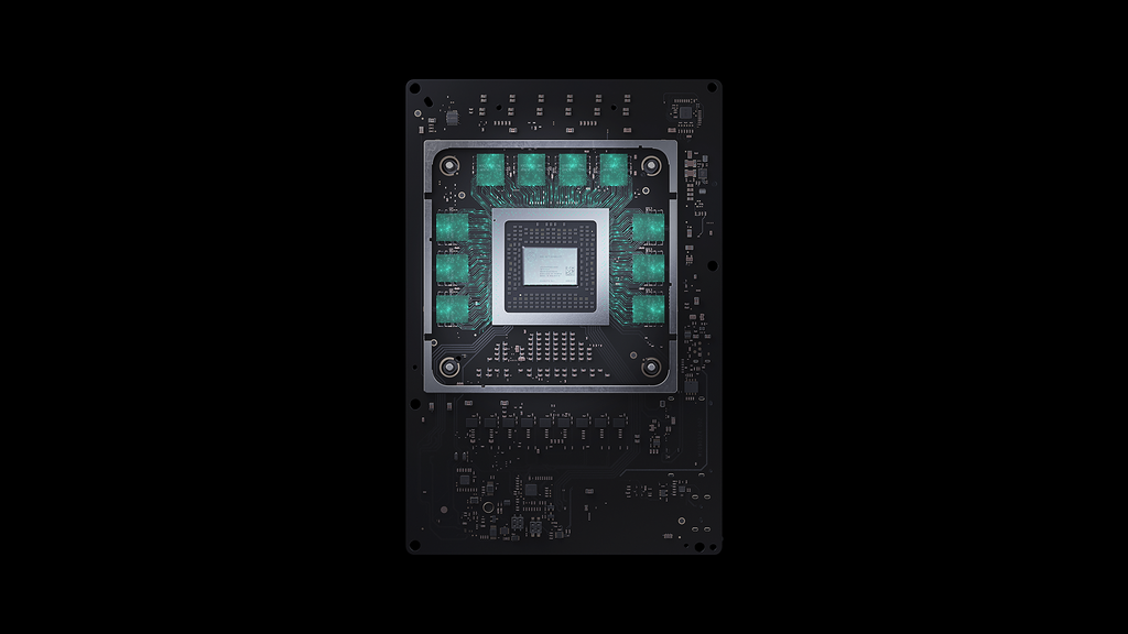 Processador customizado baseado na arquitetura Zen 2 da AMD e memórias GDDR6 são ótimas adições em matéria de custo-benefício, eficiência energética e desempenho. Na imagem, SoC do Xbox Series X rodeado pelos chips de memória