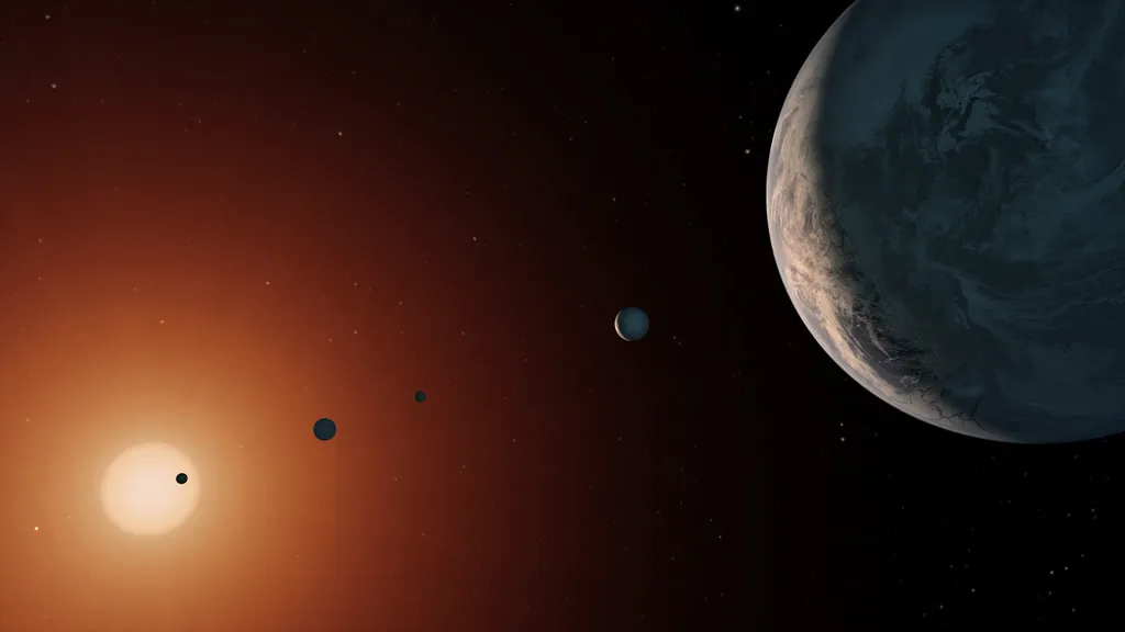 A estrela TRAPPIST-1 é orbitada por pelo menos sete planetas, sendo que três deles ficam em uma região em que a água pode existir no estado líquido (Imagem: Reprodução/NASA/JPL-Caltech)
