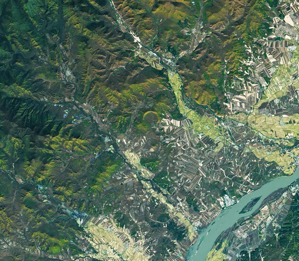 A cratera, quase no centro da imagem, fica em uma região densamente arborizada da cordilheira de Lesser Xing'an (Imagem: Reprodução/NASA Earth Observatory)