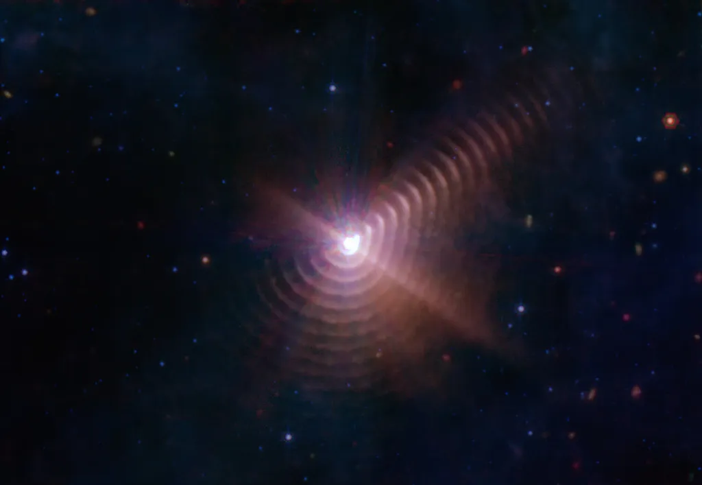 Par de estrelas Wolf-Rayet acompanhado de pelo menos 17 anéis de poeira emanando da dupla (Imagem: Reprodução/NASA/ESA/CSA/STScI/JPL-Caltech)